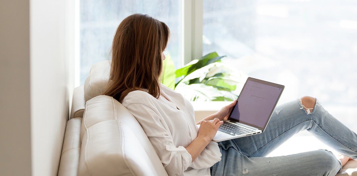 A women is operating a laptop